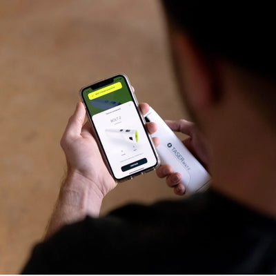 Man pairing TASER Bolt 2 with mobile app on smartphone for Bluetooth connectivity