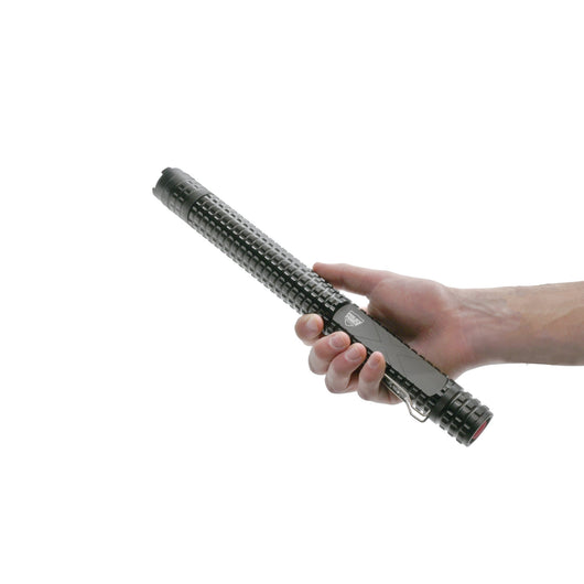 Hand holding Police Force Tactical stun baton with textured grip and built-in clip, compact self-defense tool.