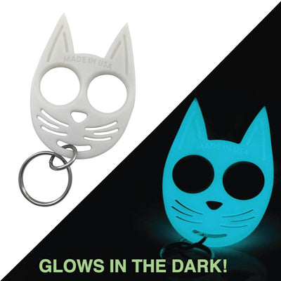 White glow-in-the-dark cat self-defense keychain shown glowing at night