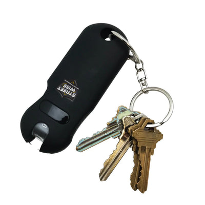 Streetwise black keychain stun gun attached to a set of brass keys, compact self-defense device with built-in keyring