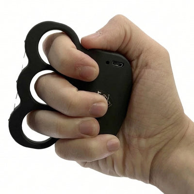 Streetwise knuckle stun gun held in hand, showing compact self-defense grip design