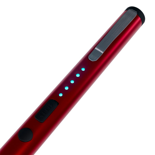Close-up of red pen stun gun showing LED battery indicator lights and safety switch