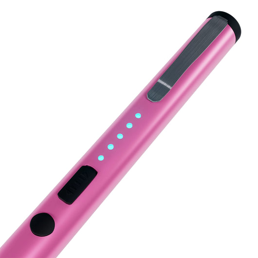 Close-up of pink pen stun gun showing LED battery indicator lights and safety switch