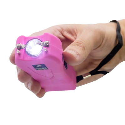 Streetwise pink Lifeguard Auto Stun Gun LED flashlight on, demonstrating dual function