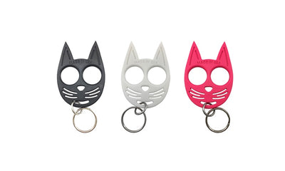 Set of three cat-shaped self-defense keychains in black, white, and pink with finger holes