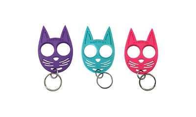 Colorful cat self-defense keychains in purple, teal, and pink with finger holes