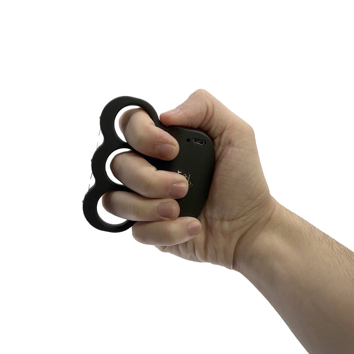Streetwise knuckle stun gun held in hand, showing compact self-defense grip design